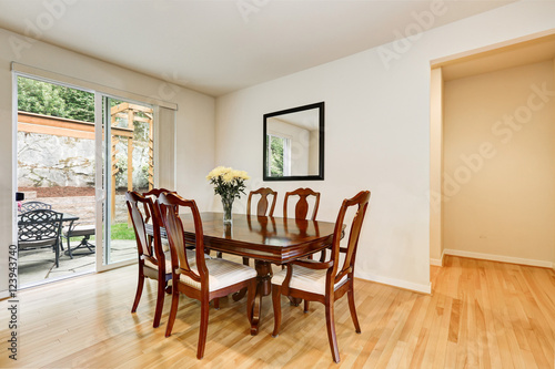 Light dining room with wooden carved table and chair set © Iriana Shiyan