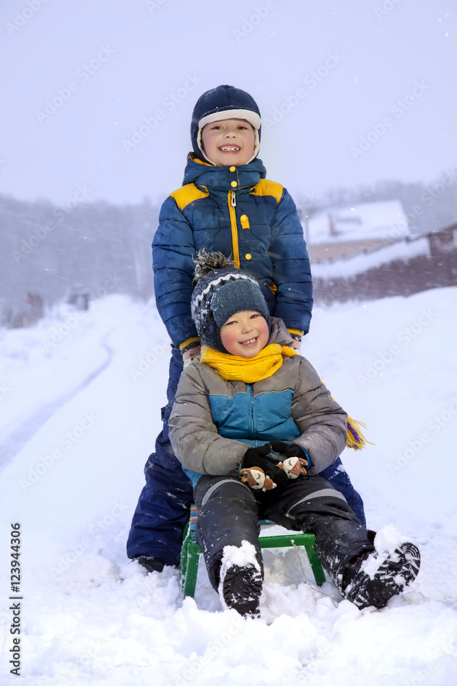 happy boys on sled