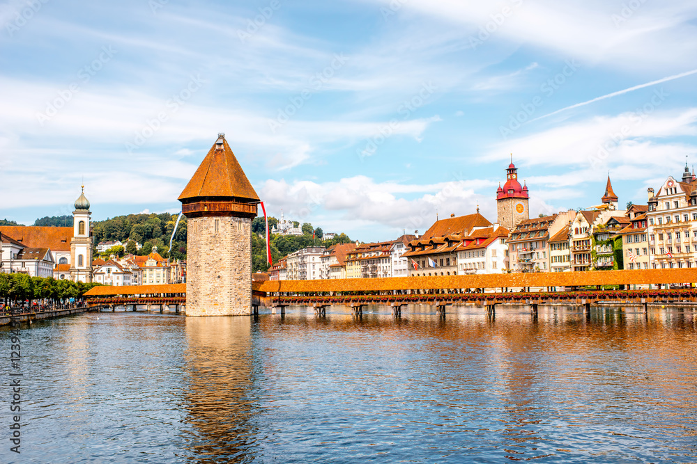 Cityscape view on the famous wooden bridge with tower on Reuss river in Lucerne old town in Switzerland