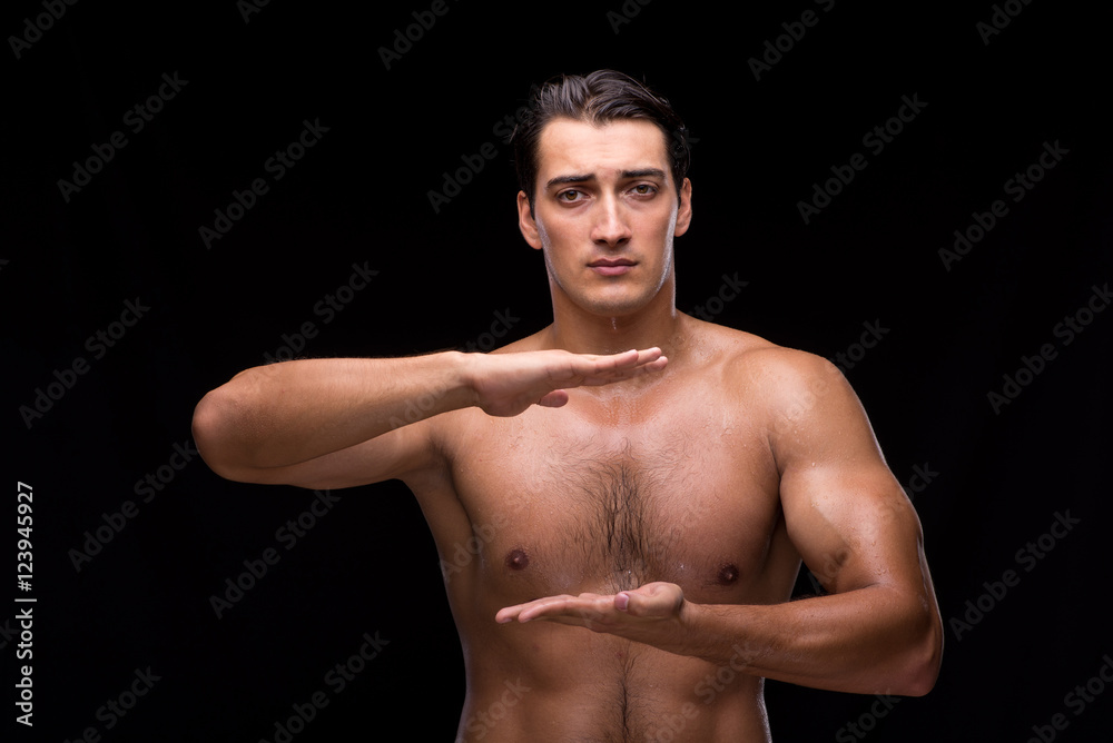 Fototapeta premium Ripped muscular man pressing virtual buttons