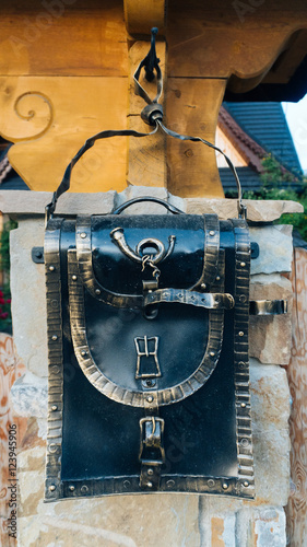 An perspective view of an old school retro tin mailbox bulging on an isolated background