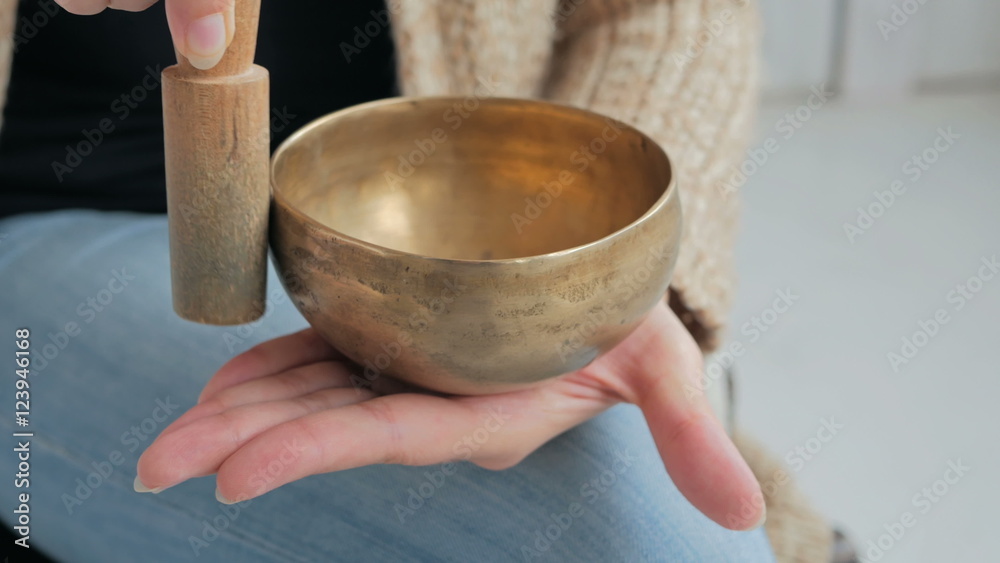 Close up shot of nepal singing bowl in woman's hand. Meditation and relax concept