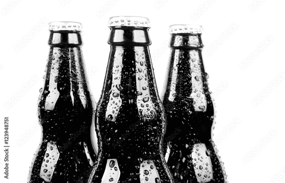three glass black bottles of beer, isolated on white background