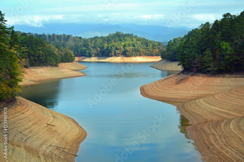 Drought-stricken lake in North Carolina, USA, with Smoky Mountains in the background