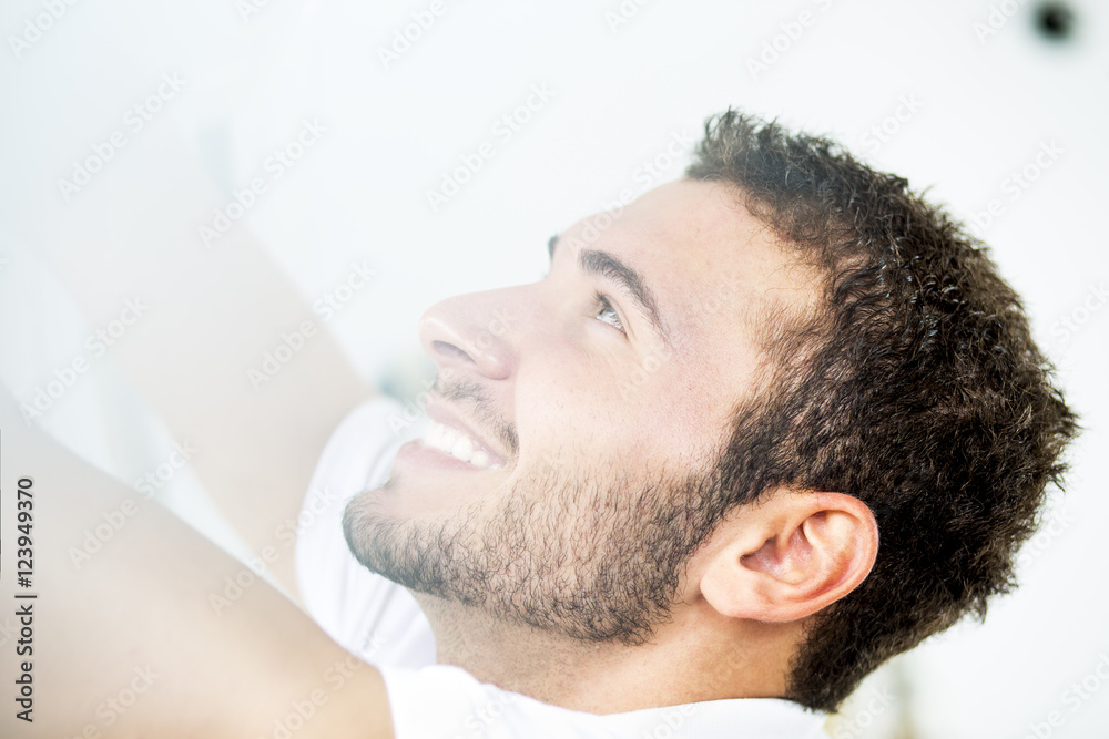 Obraz premium Young handsome man. Pretty young guy looking throw window. Close up. Profile. 