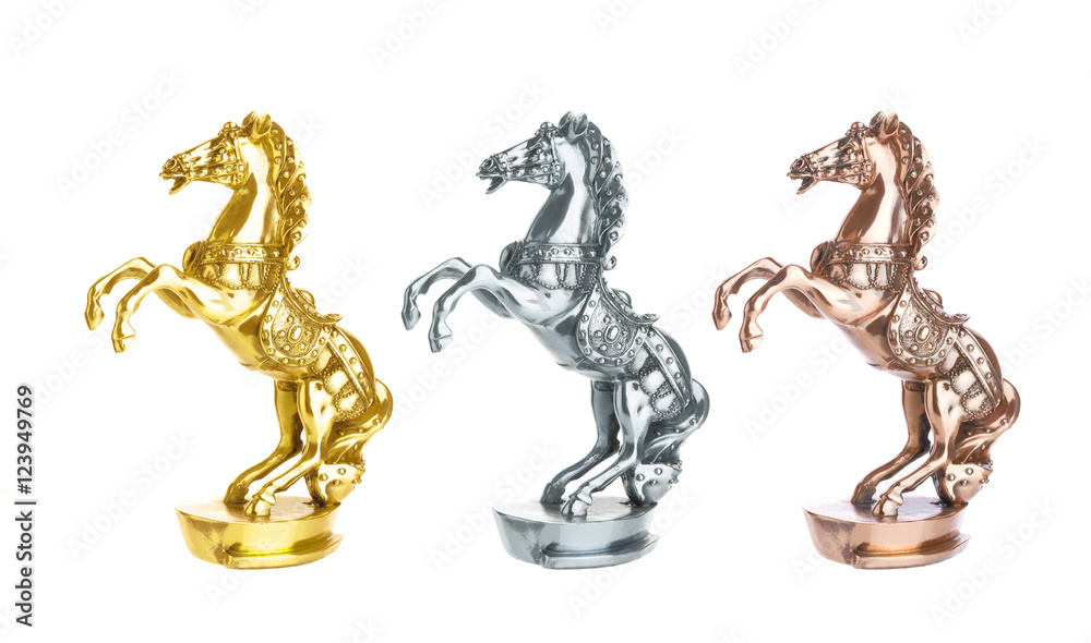 Fototapeta premium Statuette of horse isolated on white. Gold, silver and bronze statue trophy on horse racing