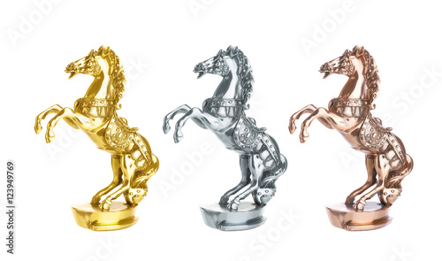 Statuette of horse isolated on white. Gold, silver and bronze statue trophy on horse racing