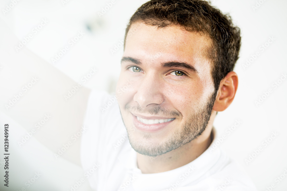 Obraz premium Young handsome man. Pretty young guy looking throw window. Close up. Profile.