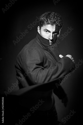 Portrait of a handsome young man in black body painting