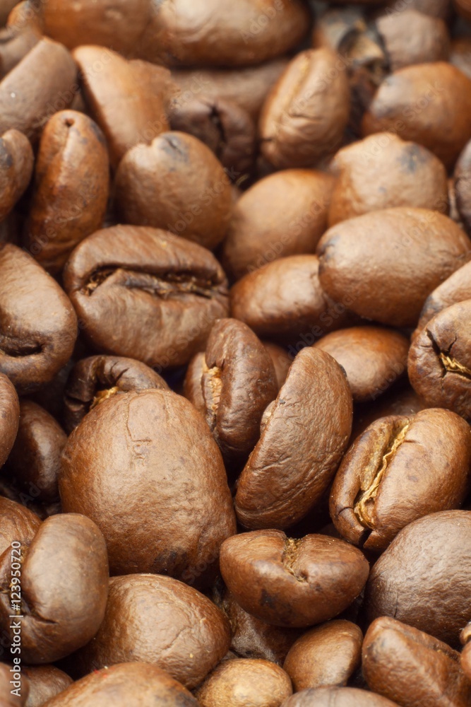 Details of Roasted coffee beans. Close up shot of a pile of roasted coffee beans
Details of Roasted coffee beans. Close up shot of a pile of roasted coffee beans