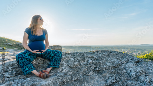 Pregnant Woman Rest in Sunset in Montains