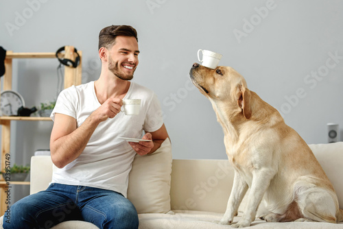 dog with a mug on its nose sitting