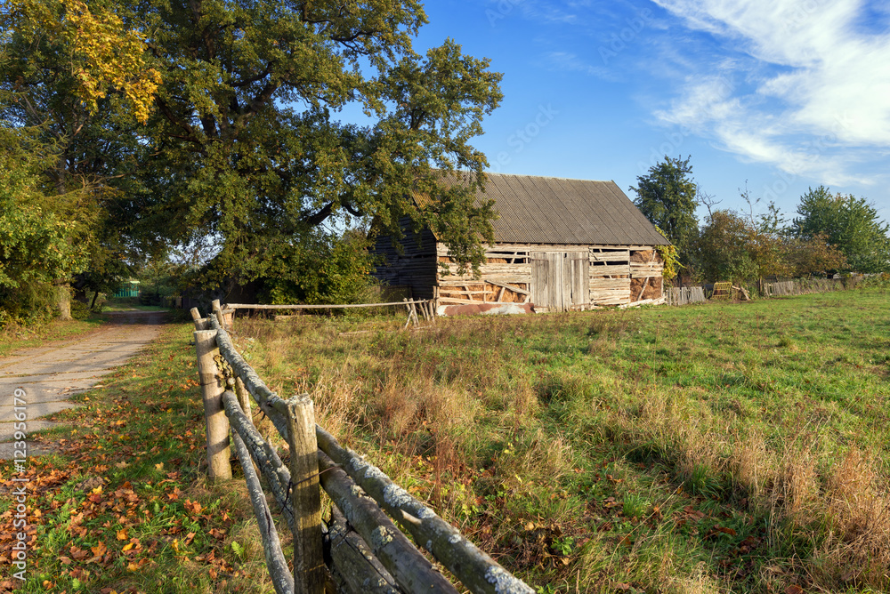 Traditional old wooden barn with hay inside. Autumn landscape. Kaszuby in Poland.