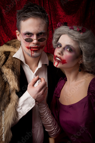 Beautiful vampires couple woman and man in medieval clothes