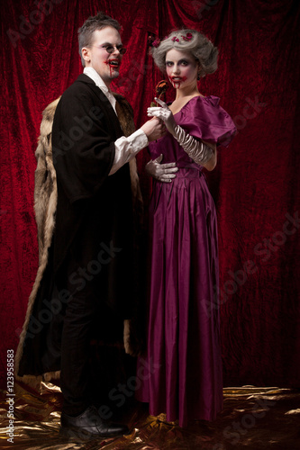 Beautiful vampires couple woman and man in medieval clothes