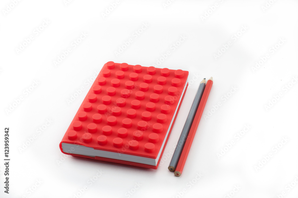 Red notebook and pencils on white background Red notebook and pencils on white background