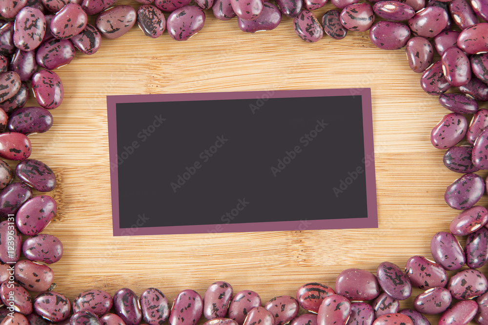 Pinto beans on the wooden background. (Phaseolus vulgaris) Pinto beans on the wooden background. (Phaseolus vulgaris)