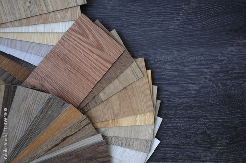 Laminate Wood Concept - Samples of laminate and vinyl floor tile on wooden Background wo photo
