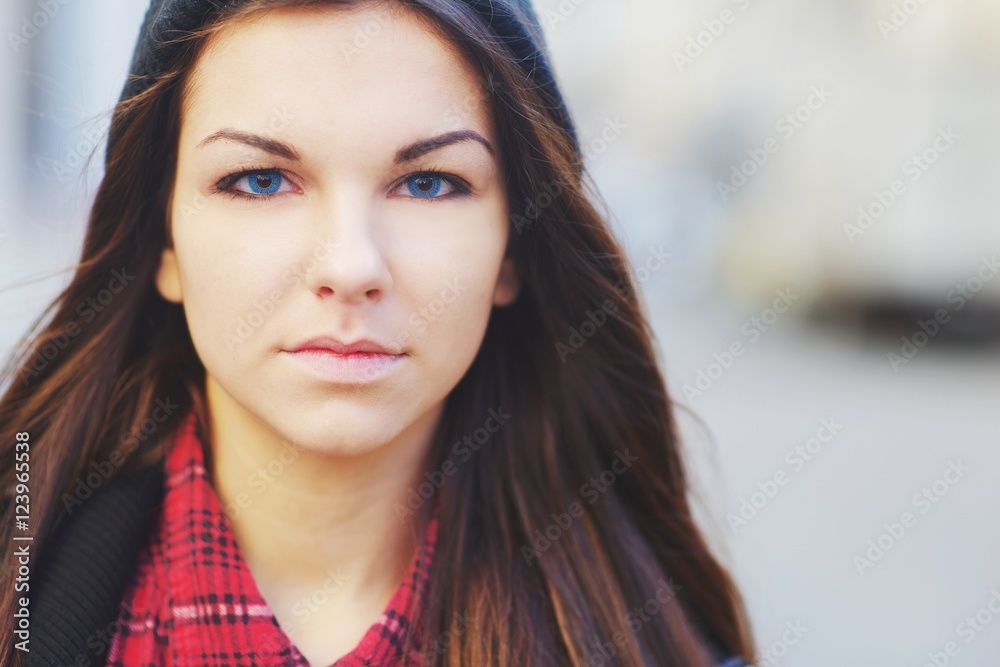 A Pretty Young Blue Eyed Brunette Girl With Long Hair In A Red Plaid Shirt And Black Hat 