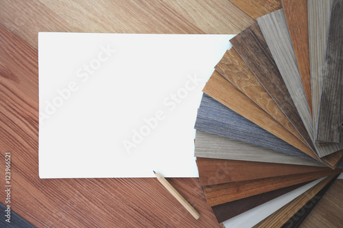 Laminate Wood Concept - Samples of laminate and vinyl floor tile on wooden Background