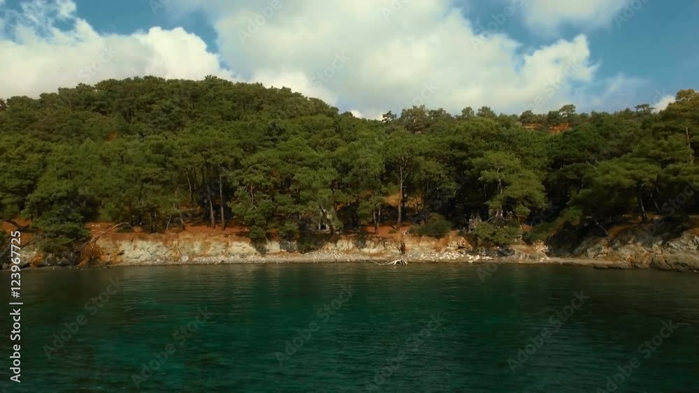 Aerial View of the Tropical Coast with Dense Forest and the Bay with the Blue Water. Sunny Day, Shot in 4K UHD Aerial View of the Tropical Coast with Dense Forest and the Bay with the Blue Water. Sunny Day, Shot in 4K UHD