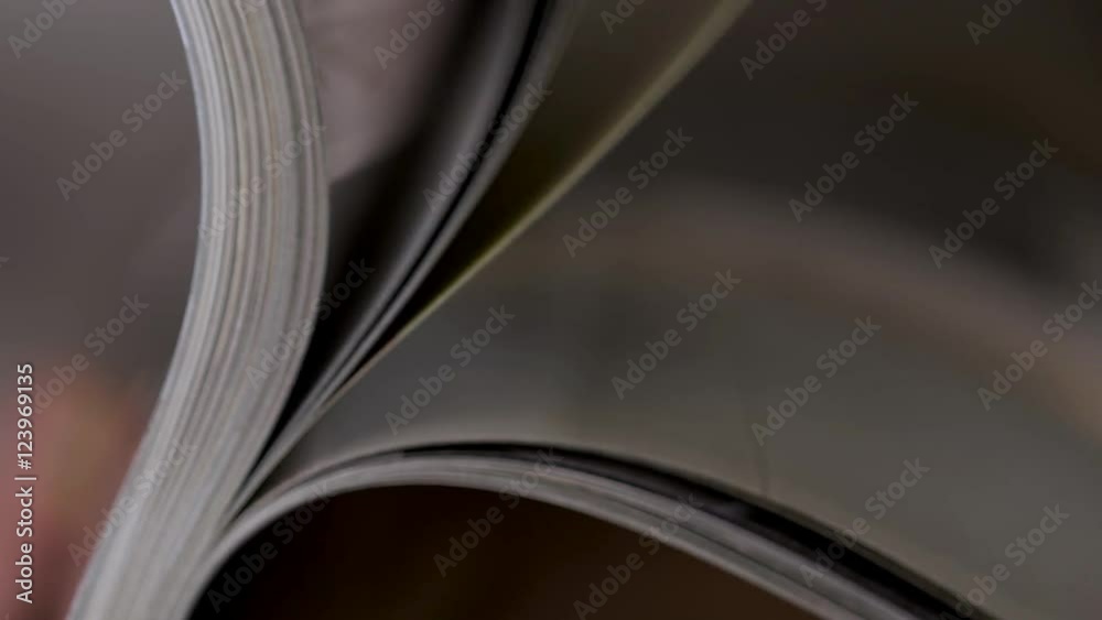 Magazine with open pages up close in man hands