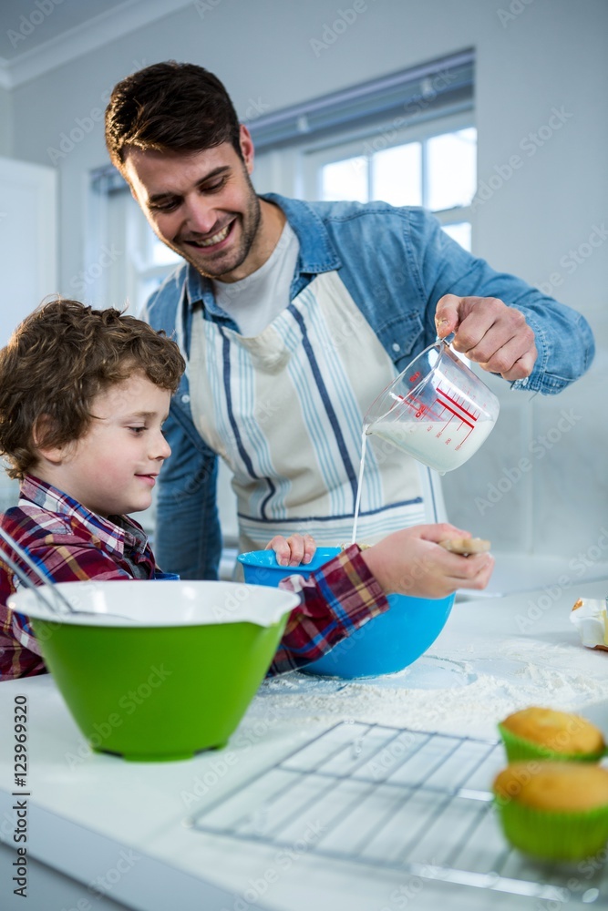 Father and son preparing cupcake