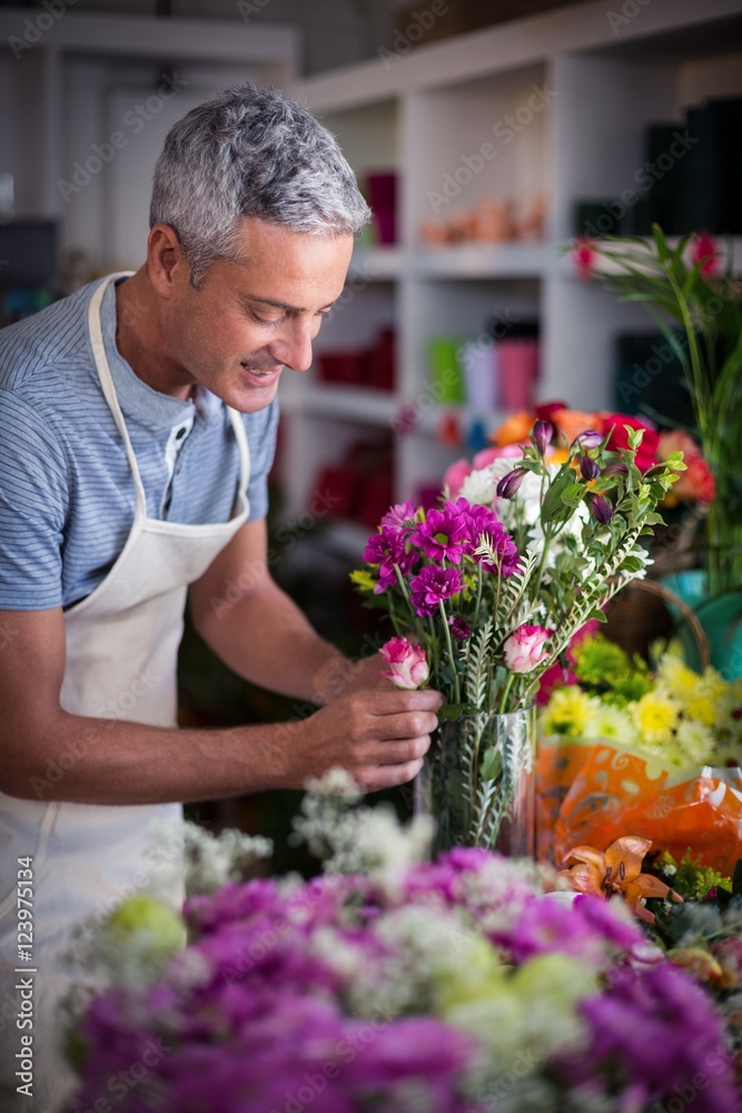 Smiling florist preparing a flower bouquet