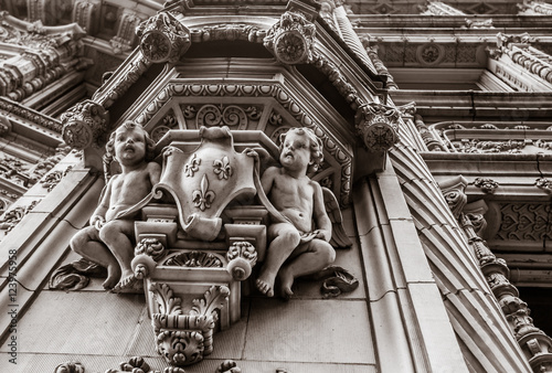 Architectural ornamental stucco molding embellishment. Cherubs, coat of arms, Fleur De Lys.