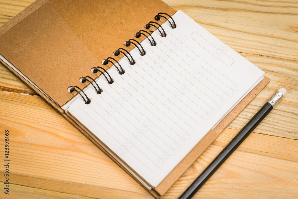 Blank open notebook with pencil on wood table Blank open notebook with pencil on wood table