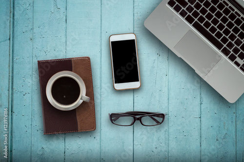 Office desk wood with computer, note book,phone and coffee cup concept in wood background.Copy space