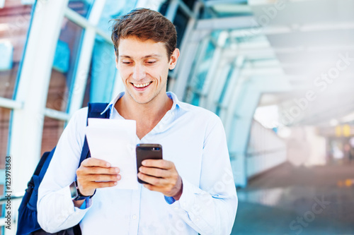 man using smart phone to book airplane tickets or do online checking