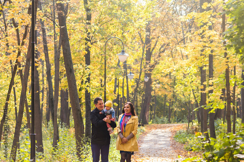 love  parenthood  family  season and people concept - smiling couple with baby in autumn park