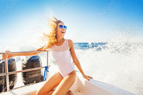 back view of a woman sailing a boat in a paradise island