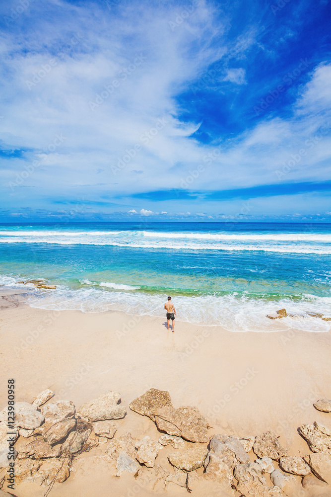 tiny figure of a man looking at the ocean tiny figure of a man looking at the ocean