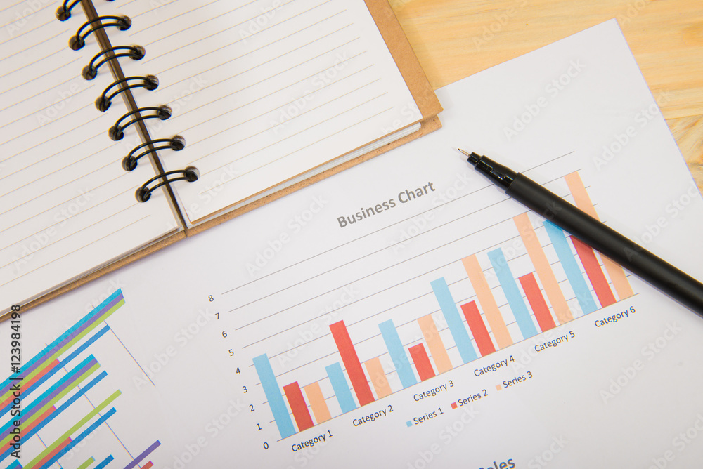 charts of growth on wood background , workplace businessman charts of growth on wood background , workplace businessman