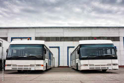 Airport buses in the parking lot near the garages