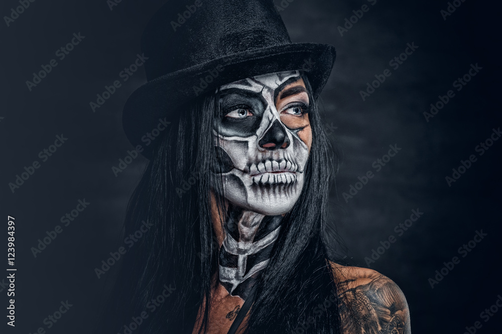A woman with skull make up in top hat on Halloween. A woman with skull make up in top hat on Halloween.
