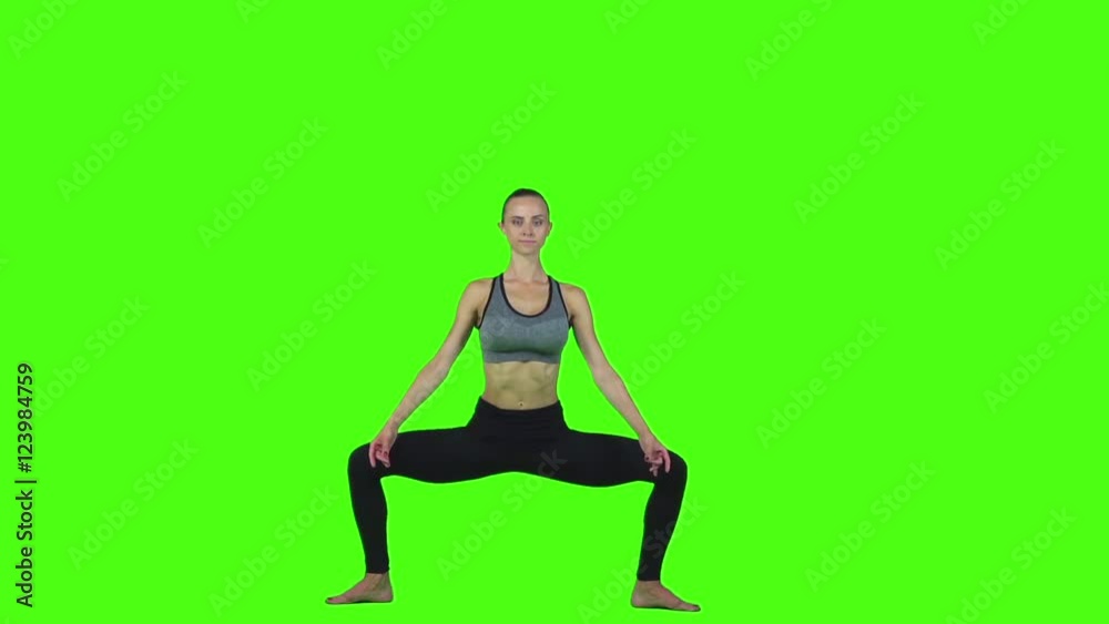 Girl doing yoga exercise in sportswear. Green screen. Slow motion Girl doing yoga exercise in sportswear. Green screen. Slow motion