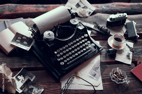 Retro typewriter on a wooden table with different vintage things