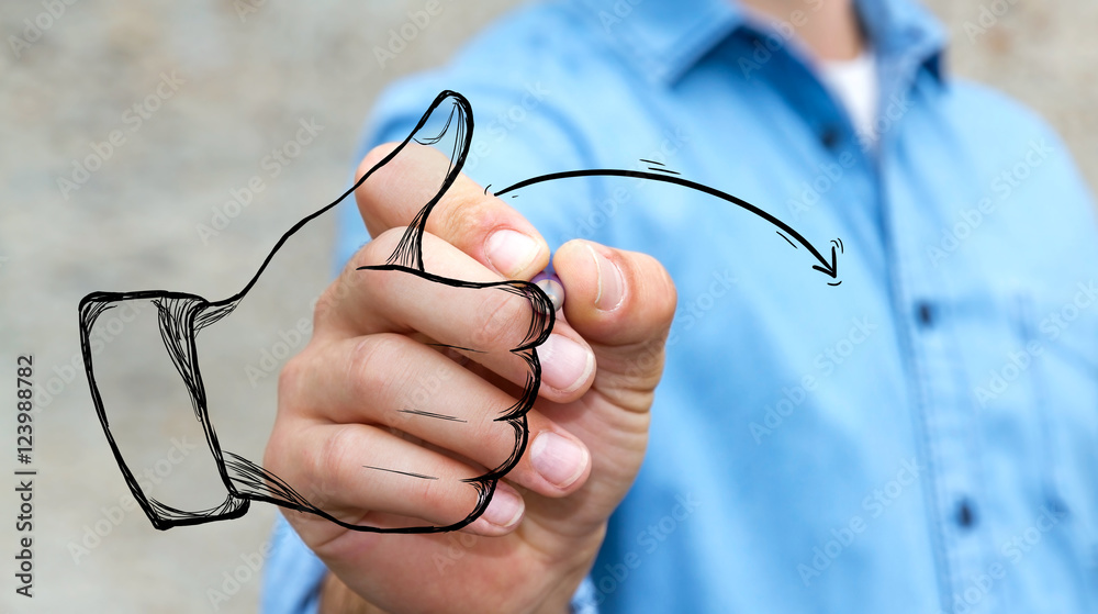 Businessman drawing thumb up illustration with a pen
