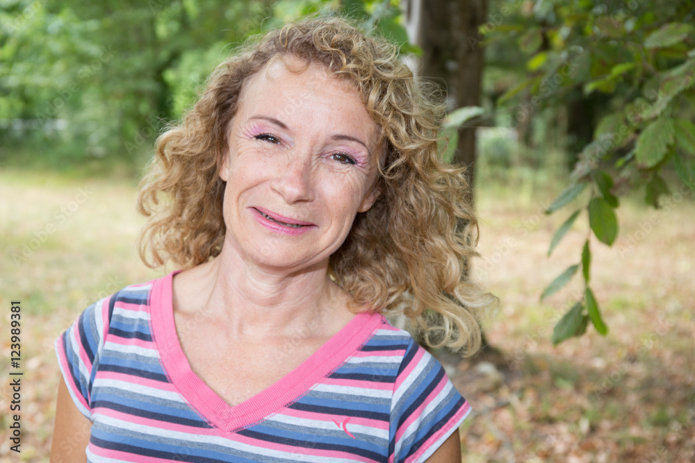 Blond smiling senior woman outdoor happy to be there Blond smiling senior woman outdoor happy to be there
