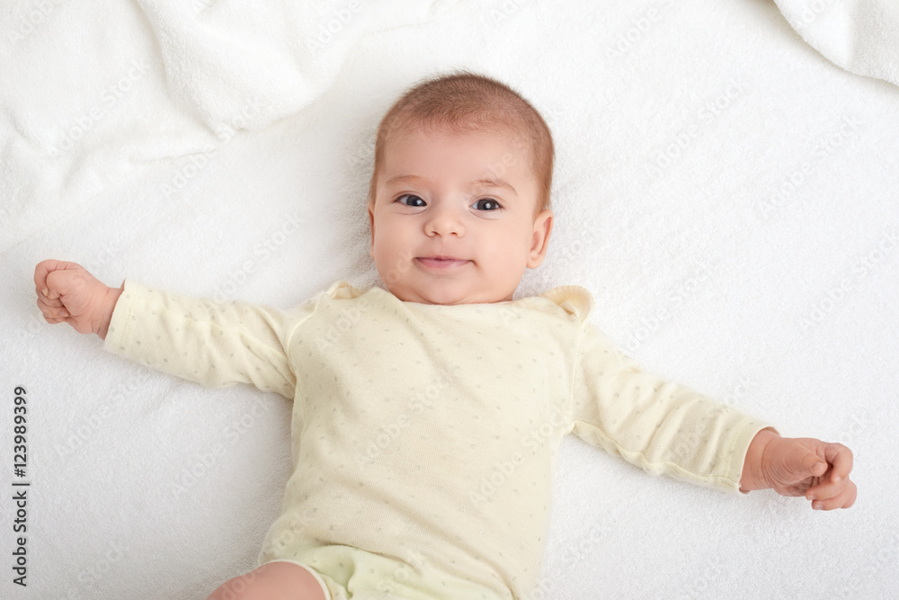 baby portrait lie on white towel in bed baby portrait lie on white towel in bed