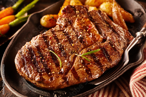 Serving of marinated rib eye steak with potatoes