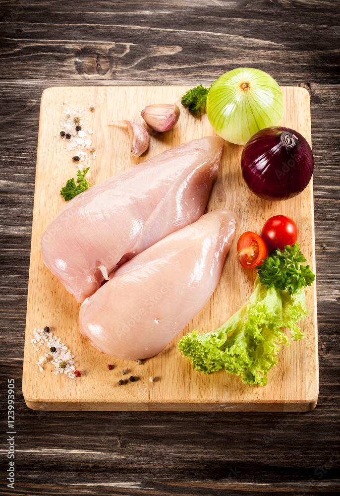 Raw chicken breasts on cutting board Raw chicken breasts on cutting board