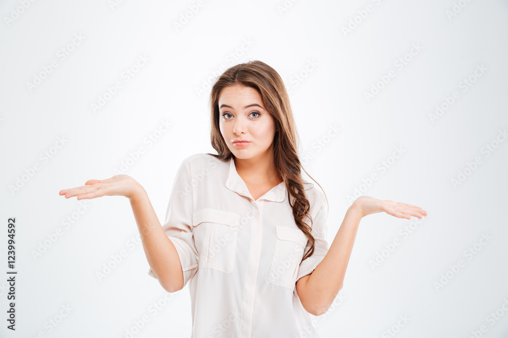 Confused thoughtful young woman holding copyspace on both palms Confused thoughtful young woman holding copyspace on both palms