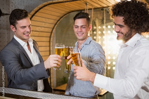 Konstfotografi Group of friends toasting a glass of beer