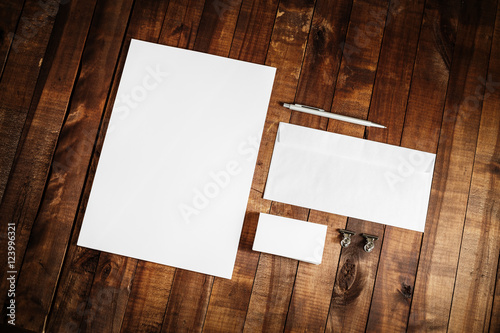 Blank stationery set on wooden table background. Blank paperwork template for design presentations and portfolios. Mock up for branding identity. Top view.
