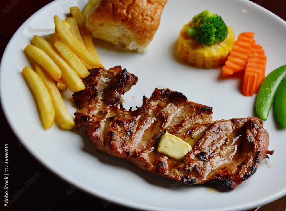 deer steaks and boiled vegetable on white plate deer steaks and boiled vegetable on white plate