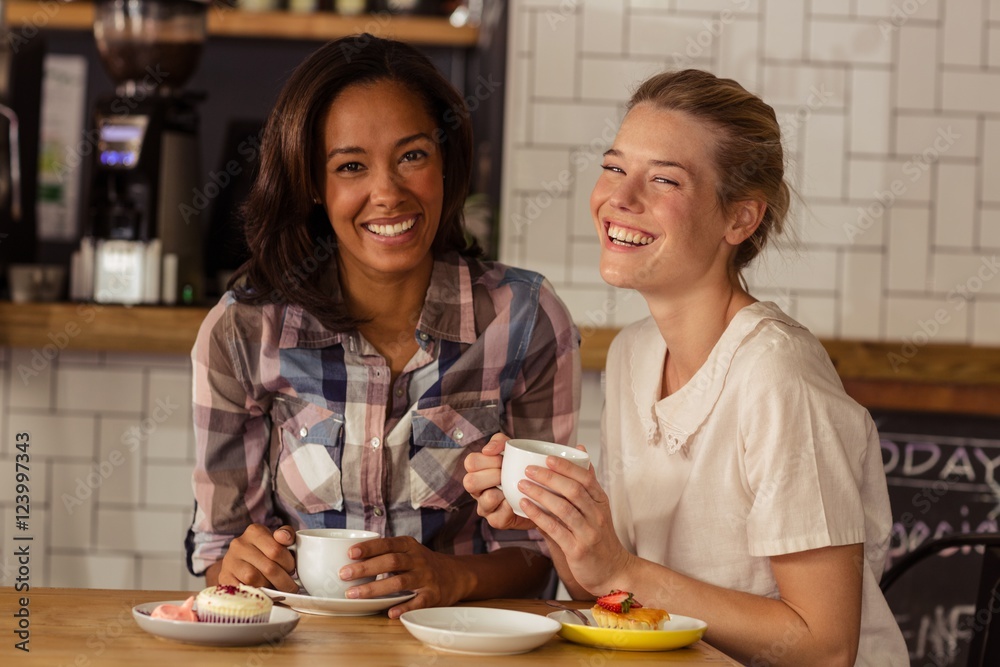 Female friends having fun while having coffee